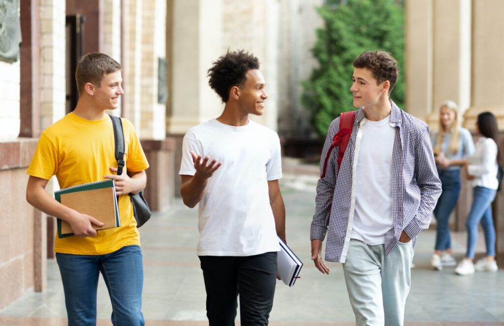 university-life-guys-walking-in-campus-and-chatting.jpg