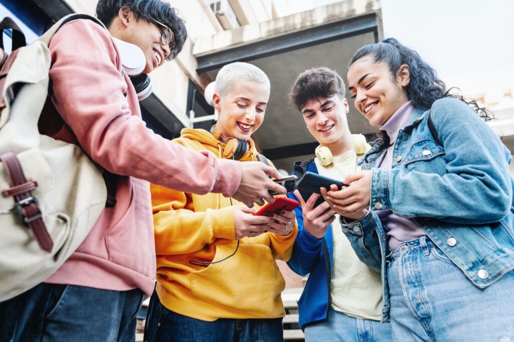 university-students-with-smart-mobile-phones-at-college-campus-teenager-friends-using-cellphones.jpg